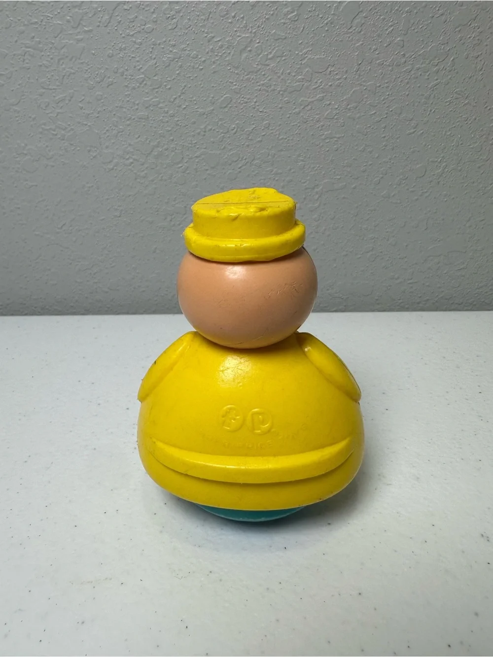 Fisher-Price Yellow Roly-Body Toy with Peach Face and Blue Base